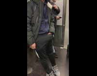 man with hand in pants