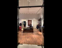 Man in suit dances to hip hop song in clothing store