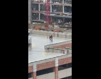 Two women poses at the rooftop parking lot