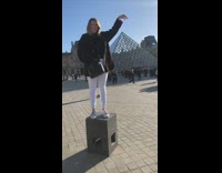 Woman take picture with The Louvre pyramid
