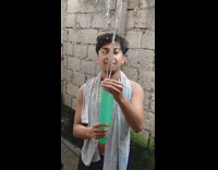 Man squirts water from a balloon in slow motion