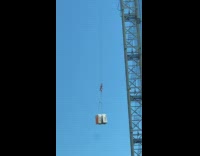 Collab DailyDoseOfInternet - Two portable toilet carried to the building top by crane