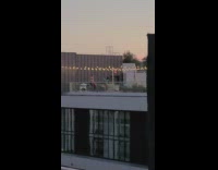 Girl pose building rooftop string lights night