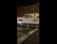 Semitruck carries yacht boat down the street