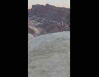Girl black bikini blue feathers headdress mountain