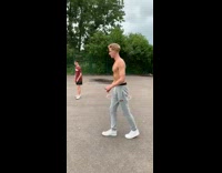 Grey sweatpants guy kicks ball hits friend 