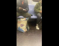 Guy grinds weed and rolls a joint on subway train