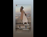 girl poses in front of city view says work it