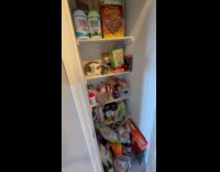 Woman opens pantry with rabbit on shelf