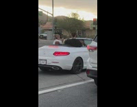 Three women dance convertible car street caught