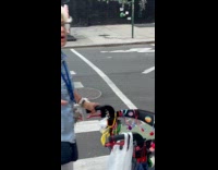 Woman reacts at dog standing on scooter