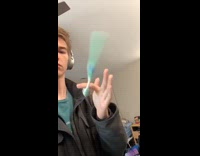 Man with headphones spins toothbrush on his finger