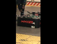 Guy Plays with Foosball Table at Station 