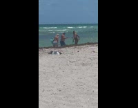 Woman bikini tiktok while man copies her beach