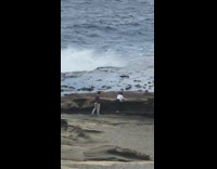 two people beach warning sign 