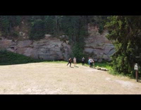 Men Dance as Aerial Drone Hovers Above Forest