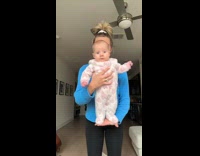 Woman showing newborn on stand up mode 