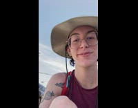 Guy in spiderman outfit walking dog on leash 