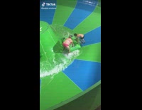 Lady Adjusts Inflatable which Cannot Fit on Slide