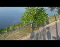 Woman gray top white boots pose sunset 