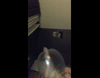 Girl blows air into condom with foot 