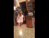 Girl tiptoes into kitchen and slips on wet floor