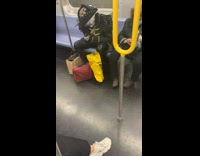 Guy sits on train in pirate outfit 