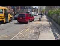 Red SUV car parked along the sidewalk with flat tire 
