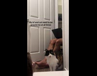 Boyfriend and cat sitting at door