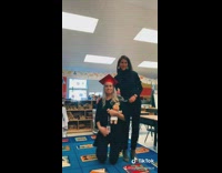 Girl takes picture with kindergarten teacher