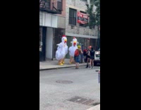 3 people in chicken costume on street