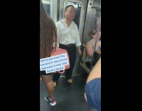 White shirt guy dances earphones subway door