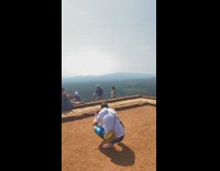 Lady stretches on rock 
