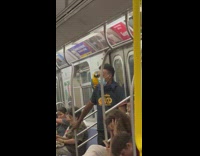 Man has a parrot on his shoulder in subway