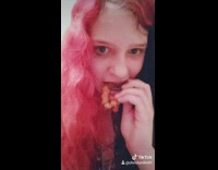 Girl bites eats fried rubber band fork
