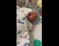 Newborn Baby Sneezes and Yawns as it Rest