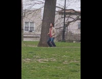 Man jacket tap his legs beside tree