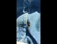 Guy blue jeans on fire small hole burning