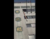 People lift long box up a building