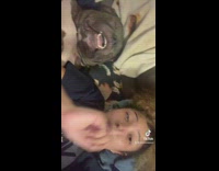 Curly Lady Lip Syncs Beside Asleep Dog