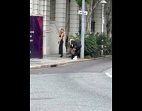 Woman black dress side holes pose on street