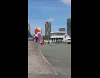 Woman black leggings do squats skater cameraman