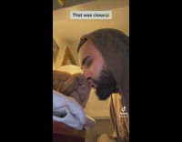 Man kisses his pet rabbit on its head 