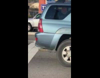 girl leaning on green electricity box