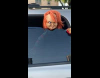 Chucky doll head peek over SUV window
