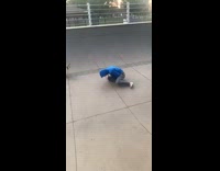 Blue sweater guy falls skateboard lands arm 