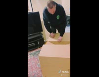 Guy surprised by puppy in cardboard box 