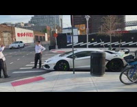 Guy Poses in Front of White Sports Car 