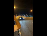 Black car leaves trail of smoke behind 