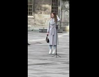 Woman poses and films herself on the street 